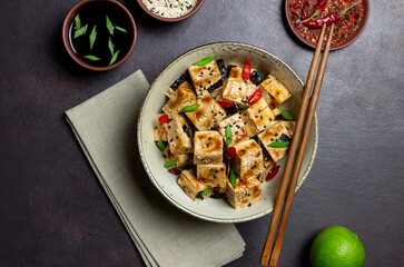 Tofu in teriyaki sauce with green onions, chili peppers and sesame. Asian food. Vegetarian food. Healthy eating.