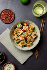 Tofu in teriyaki sauce with green onions, chili peppers and sesame. Asian food. Vegetarian food. Healthy eating.
