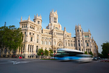 Fototapeta na wymiar Cibeles building and cars traffic at Plaza de Cibeles in Madrid on a beautiful spring day, Spain