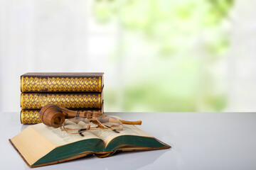 Closeup of a antique book with a tobacco pipe on them and a pair of glasses and a stack of three books in front of bright background. The teachers day. Back to school. Space. - Powered by Adobe