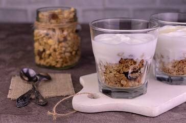Dessert of Greek yogurt and granola in a glass.	