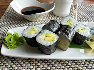 Mini rolls with avocado and soy sauce