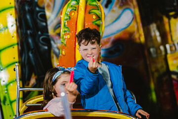 adorable children happily riding on the attractions