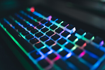 gaming keyboard with colorful light night mode modern technology gamer's workspace. High quality photo