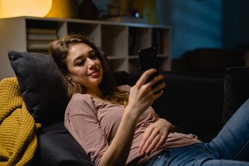 Fototapeta premium woman using mobile phone at home