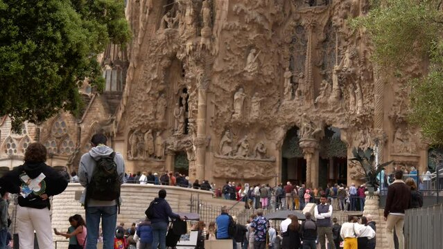 Timelapse of tourists taking pictures of the Sagrada Familia in Barcelona, Spain