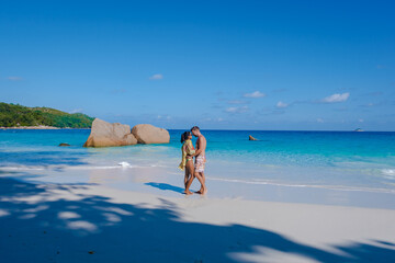 Praslin Seychelles tropical island with withe beaches and palm trees, couple men and women mid age...