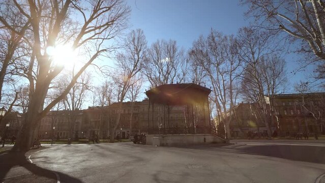 People walking in Zrinjevac Park in Zagreb in autumn at sunset
