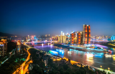 Aerial photography of the night scene of the intersection of the two rivers in Chongqing