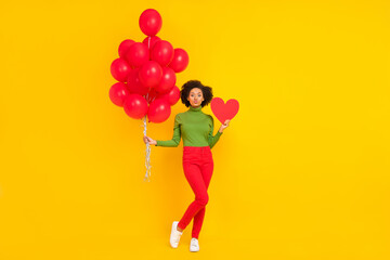Full size photo of young lovely girl hold many balloons inflate card romantic isolated over yellow color background