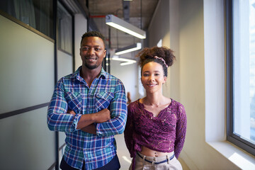Two young founders pose in the office corridor - obrazy, fototapety, plakaty
