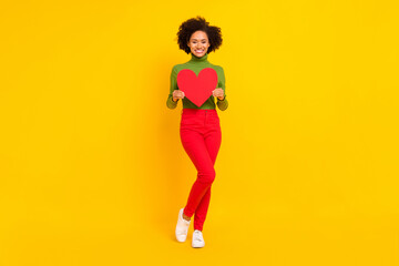 Fototapeta na wymiar Full length photo of young cheerful girl hold heart shape romance feelings girlfriend isolated over yellow color background