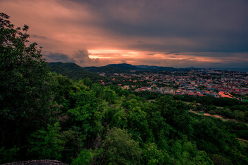 Background of mountains and nature surrounded, bright blue sky wallpaper. There are trees, green leaves, a beautiful ecology.