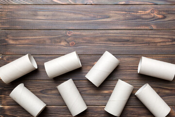 Flat lay composition with empty toilet paper rolls and space for text on color background. Recyclable paper tube with metal plug end made of kraft paper or cardboard
