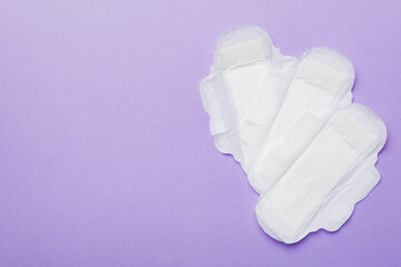 Women hygiene products or sanitary pad on colored background. Pastel color. Closeup. Empty place for text. Female daily hygiene