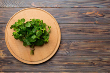 Fresh mint on Cutting board table, top view. Flat lay Space for text