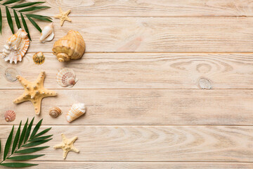 Summer time concept Flat lay composition with beautiful starfish and sea shells on colored table, top view with copy space for text