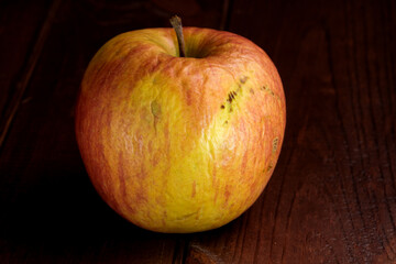 Spoiled shriveled rotten apple