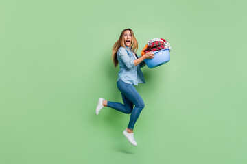 Full size photo of mature lady run wash cloth wear shirt jeans footwear isolated on green background