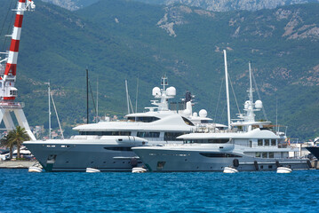 Two luxury white yachts moored in the port