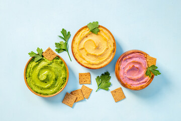 Various types of hummus with chickpeas spinach and beets. Flatlay top view