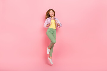 Photo of confident charismatic healthy lady jump wear casual jacket trousers sneakers isolated pink color background