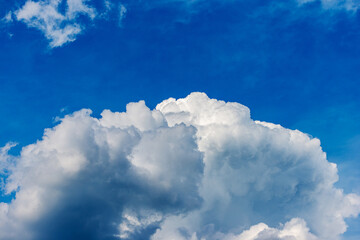 Beautiful storm clouds, cumulus clouds or cumulonimbus against a clear blue sky. Photography, full frame, sky only.