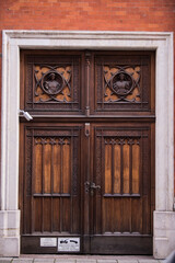 Obraz premium Munich, Germany - May 01, 2022: Old Decorative Main Entrance Wooden Door.