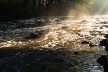 The current of the rushing river, close-up. Fast flowing water.