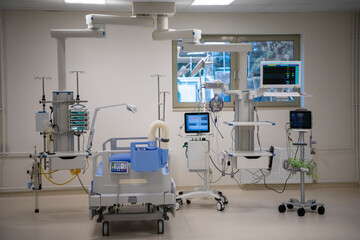 Empty Modern technology in intensive care unit room with different equipment and devices, beds and pillows.