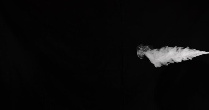 Slow motion stream of smoke from right side of frame that moves towards the center. Shot on black for easy compositing in either vertical or horizontal orientation.