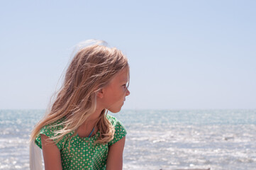 portrait of a girl in profile on summer day at sea