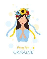 Beautiful ukrainian woman in a wreath with flowers prays for Ukraine. Stop war.