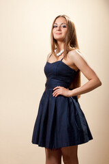 Fashionable young woman weared in dark blue evening dress