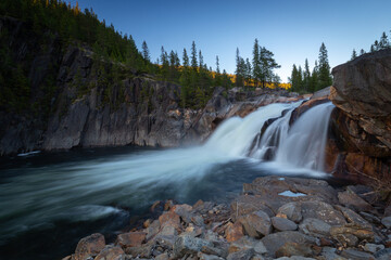 Fototapeta na wymiar Flowing waterfall Hyttfossen with evening light.