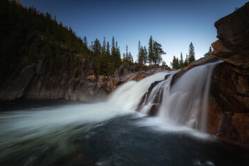 Flowing waterfall Hyttfossen with evening light.