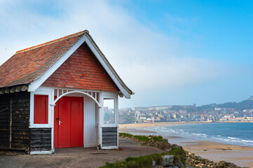 Colorful old beach huts or summer houses on South Bay Beach at Scarborough, Yorkshire, UK. Houses are old, paint cracks