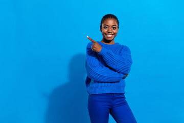 Portrait of attractive cheerful girl demonstrating copy blank space indicate select isolated over bright blue color background