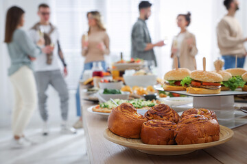 Brunch table setting with different delicious food.and blurred view of people on background