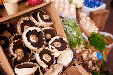 Fresh portobello mushrooms on display at a vegetable stall