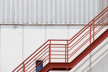red fire exit stair of industry factory, outdoor fire escape ladder of warehouse.