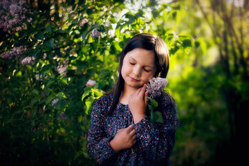 Dziewczyna podziwia przyrodę, wącha kwiaty, czyta książkę, przytula lalki