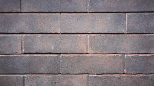 Fototapeta Gray brick wall close up. Background of brick wall