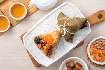 Zongzi. Rice dumpling for Dragon Boat Festival on bright wooden table background with ingredient.