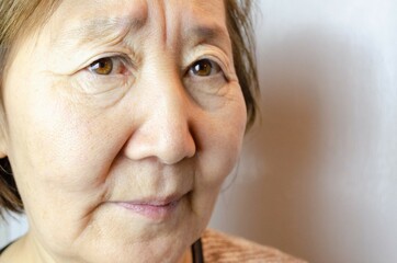 Angry asian senior woman. Look angrily at camera with grimacing mad face, dissatisfied mature lady show irritation and discontent, having bad mood negative emotions