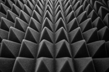 geometric black and white background of acoustic foam in the form of pyramids. Perspective abstract...