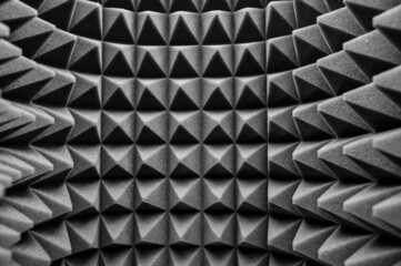 geometric black and white background of acoustic foam in the form of pyramids. Perspective abstract distortions 3d