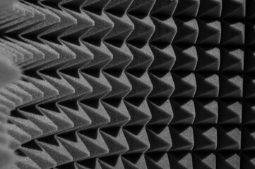 geometric black and white background of acoustic foam in the form of pyramids. Perspective abstract distortions 3d