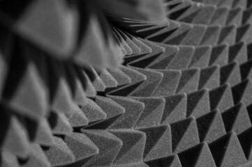 geometric black and white background of acoustic foam in the form of pyramids. Perspective abstract distortions 3d
