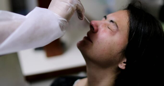 Woman having COVID nose test PCR procedure